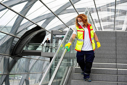 Mitarbeiterin des Hochbahn-Hygieneteams reinigt Handlauf.